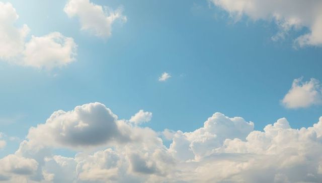 Fluffy Cumulus Clouds Against Clear Skies in Tranquil Setting