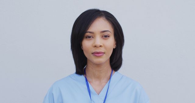 Professional Healthcare Worker in Light Blue Scrubs with ID Badge - Download Free Stock Images Pikwizard.com