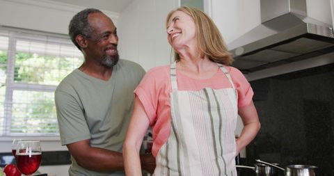 Loving Senior Couple Having Fun in Kitchen While Cooking - Download Free Stock Images Pikwizard.com
