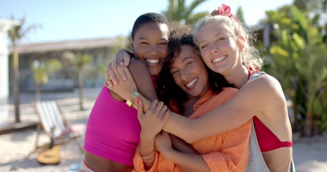 Three Women Hugging and Smiling on a Tropical Beach - Download Free Stock Images Pikwizard.com