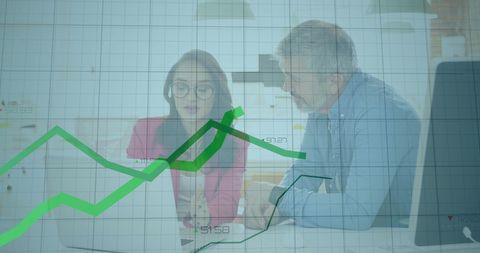 Business professionals analyzing financial trends in office