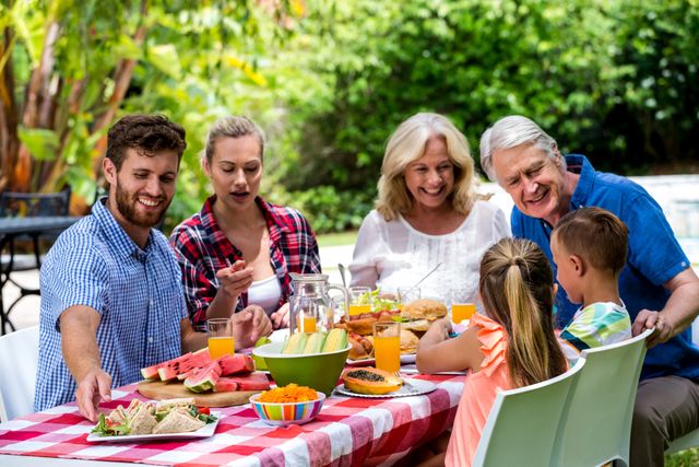 Happy Multigenerational Family Enjoying Outdoor Lunch - Download Free Stock Photos Pikwizard.com