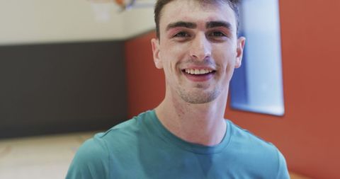 Confident Male Basketball Player Smiling on Indoor Court - Download Free Stock Images Pikwizard.com