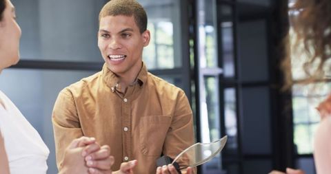 Diverse Professional Team Celebrating Achievements in Modern Office