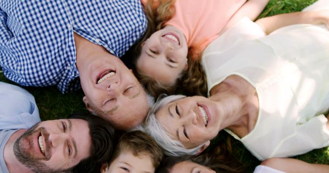 Smiling Multigenerational Family Lying on Grass Bonding Outdoors - Download Free Stock Images Pikwizard.com