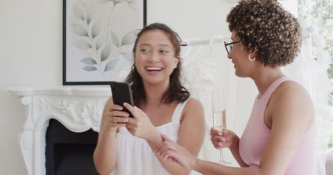 Bridesmaids enjoying wedding preparations with champagne
