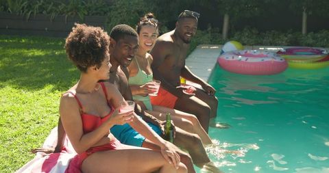 Diverse Friends Enjoying Refreshing Moments at Backyard Poolside