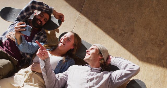 Friends Relaxing on Skate Ramp Capturing Selfie Moments - Download Free Stock Images Pikwizard.com