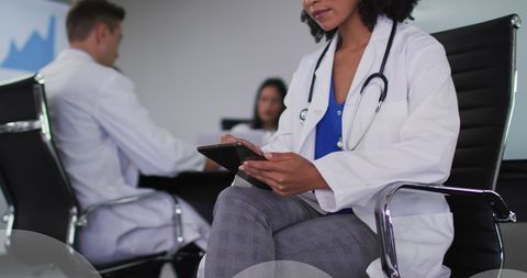 Female Doctor Using Tablet with Cloud Computing Overlay