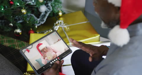 Man on Video Call Celebrating Virtual Christmas with Gifts