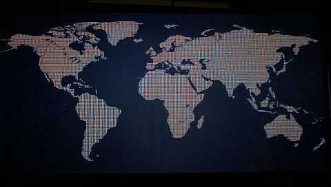 Led world map display highlighting global connectivity and data exchange