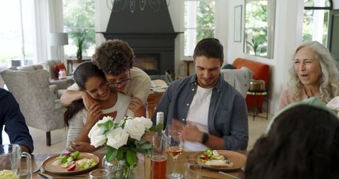 Joyful Family Dinner Gathering with Laughter and Togetherness