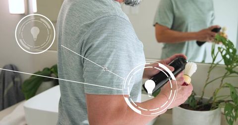 Man applying shaving cream at bathroom vanity with augmented reality grooming overlay