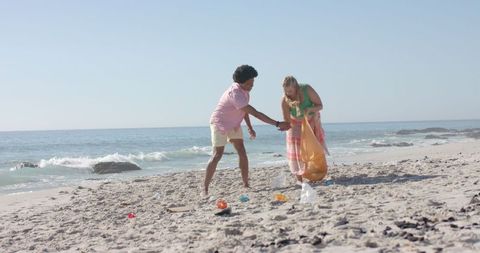 Team cleaning beach promoting environmental responsibility