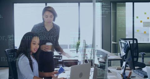 Female Colleagues Discussing Project in Modern Office