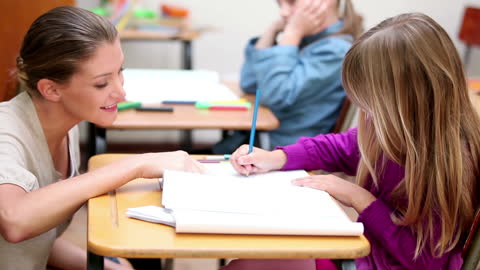 Dedicated Teacher Assisting Student in Engaged Learning