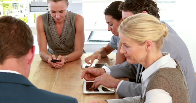 Professionals Collaborating Around Office Table With Digital Devices - Download Free Stock Images Pikwizard.com