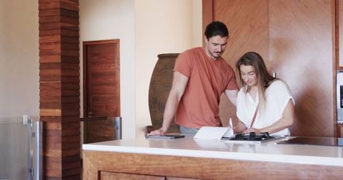 Couple Signing Lease in Modern Kitchen of New Home