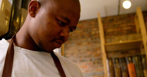 Male employee using tablet in supermarket interior