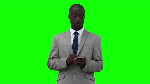 Business Professional Using Smartphone, Standing Against Green Screen