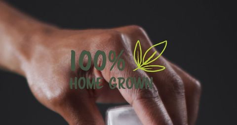 Close-up of hand with 100% home grown cannabis concept
