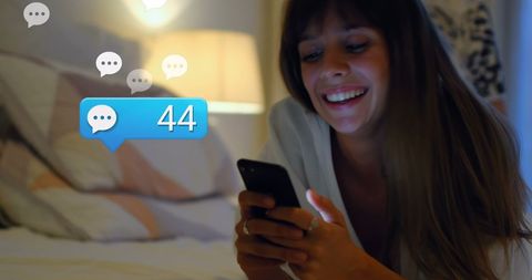 Cheerful Woman Engaged with Social Media Notifications at Home - Download Free Stock Images Pikwizard.com