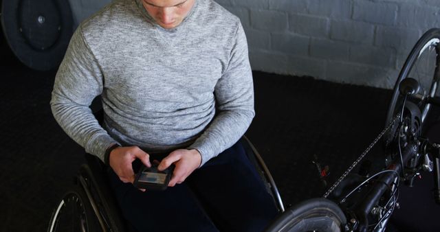 Man in Wheelchair Using Smartphone in Gym - Download Free Stock Images Pikwizard.com