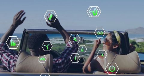 Interracial couple enjoying beachside drive with sustainable energy elements