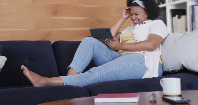 Smiling Woman Relaxing on Couch with Tablet at Home - Download Free Stock Images Pikwizard.com