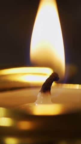 Wick Flickering and Flame Rising Over Melting Wax Close-Up Vertical Candle Footage