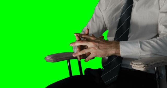 Mid section of man touching digital screen against green screen background 