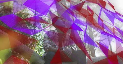 Contemplative man sitting on log in sunlit woodland with purple geometric overlay