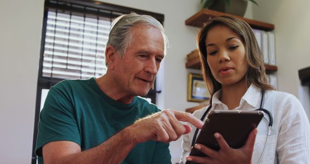 Senior Man Consulting Young Doctor Using Digital Tablet in Office - Download Free Stock Images Pikwizard.com