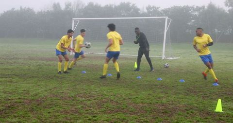 Misty morning soccer practice with men's team at training ground