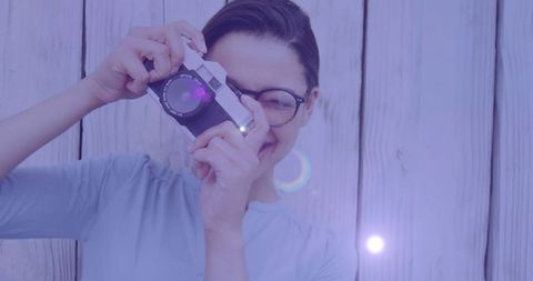 Young Woman Capturing Image with Camera on Wooden Background - Download Free Stock Images Pikwizard.com