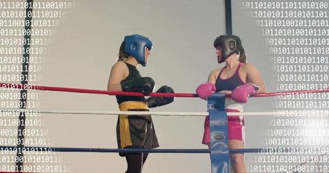 Female boxers sparring in boxing ring with binary code overlay, digital fitness concept