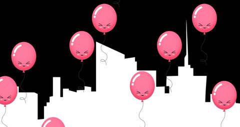 Pink balloons hovering above city silhouette