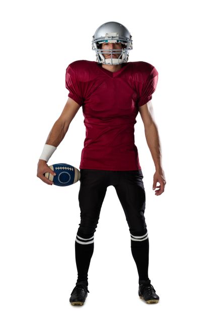 Full length of determined American football player wearing helmet standing against white background