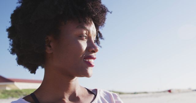 Young Woman with Afro Hairstyle Smiling Outdoors - Download Free Stock Images Pikwizard.com