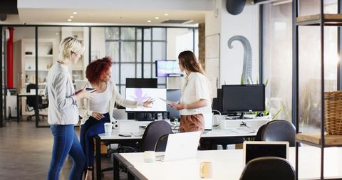 Diverse Female Colleagues Teaming Up in Modern Open-Plan Office