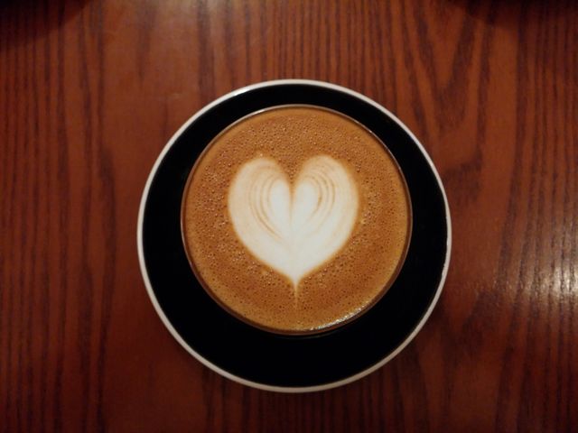 Heart-shaped Latte Art in Black Cup on Wooden Table - Download Free Stock Photos Pikwizard.com