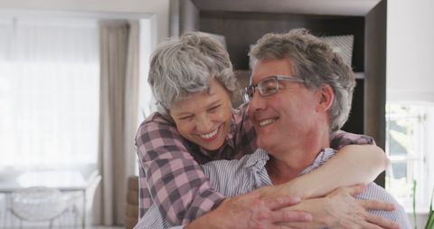 Joyful Senior Couple Embracing at Home in Cozy Living Room - Download Free Stock Images Pikwizard.com