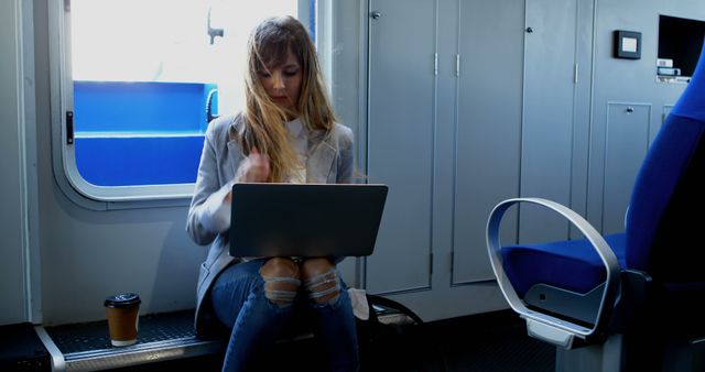 Young Woman Working on Laptop while Traveling in Train - Download Free Stock Images Pikwizard.com