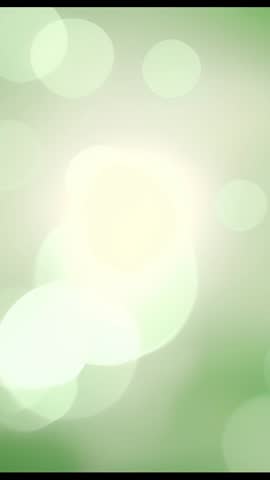 Soothing green bokeh gradient vertical video with soft light orbs for calm backgrounds
