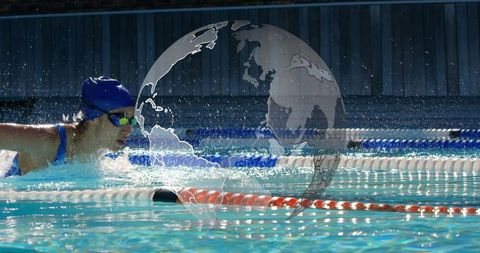 Competitive swimmer breathing during lap with globe graphic overlay and splashing water