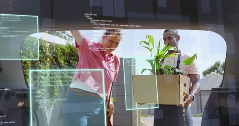 Two adults loading houseplant into car trunk with augmented reality delivery interface