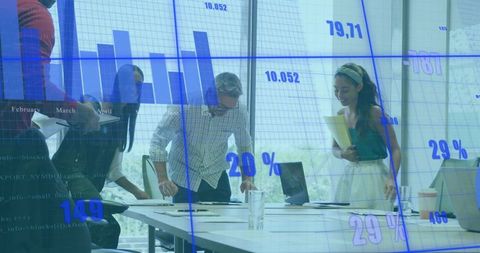 Business Team Analyzing Financial Data in Modern Glass Office