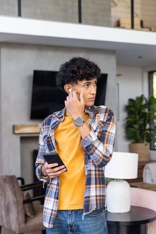 Man Engaging with Wireless Technology in Modern Living Room