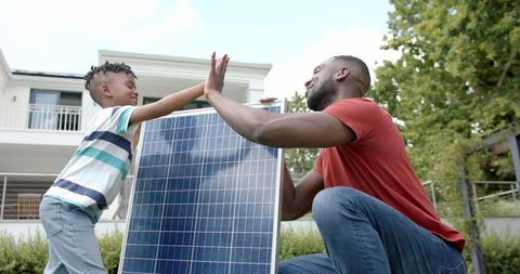 Father and Son Bonding Over Solar Energy Project Outdoors