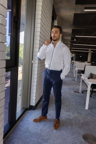 Professional Worker Using Smartphone in Modern Office Setting